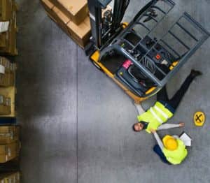 man laying on ground after forklift accident